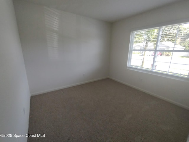 565 Sorrento Dr, Cocoa, FL 32922 - empty room with carpet flooring and baseboards