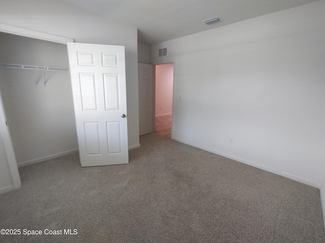 565 Sorrento Dr, Cocoa, FL 32922 - unfurnished bedroom featuring carpet floors, a closet, and baseboards