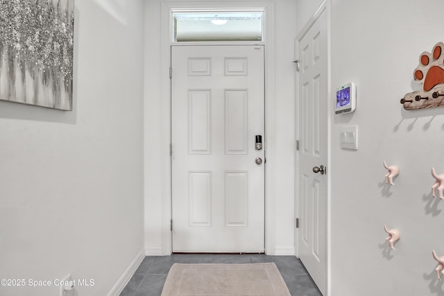 1265 Valley View Ave, Rockledge, FL 32955 - entryway featuring dark tile patterned floors and baseboards