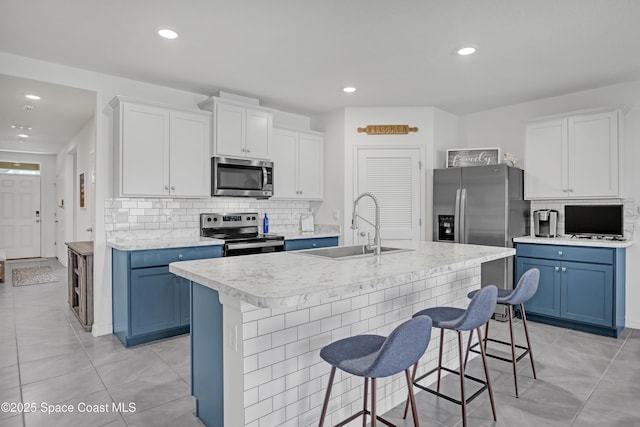 1265 Valley View Ave, Rockledge, FL 32955 - kitchen featuring appliances with stainless steel finishes, blue cabinets, backsplash, and recessed lighting