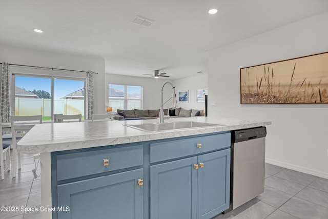 1265 Valley View Ave, Rockledge, FL 32955 - kitchen featuring stainless steel dishwasher, blue cabinetry, open floor plan, a kitchen island with sink, and light tile patterned flooring