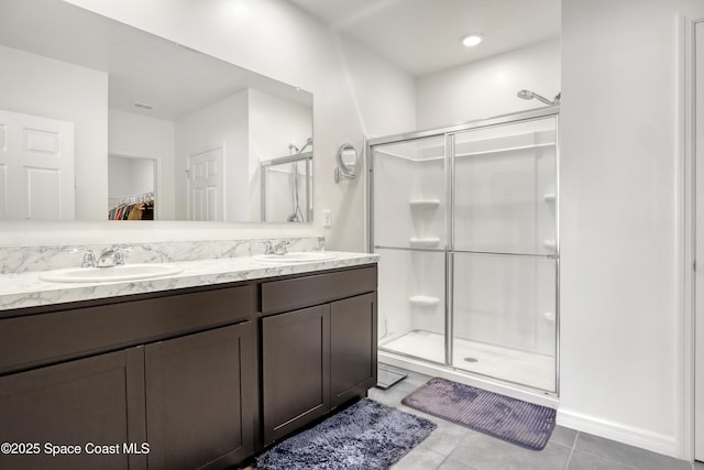1265 Valley View Ave, Rockledge, FL 32955 - bathroom with a shower stall, double vanity, tile patterned flooring, and a walk in closet