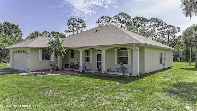 386 Valencia Rd, Melbourne, FL 32904 - rear view of house with a porch, a yard, an attached garage, stucco siding, and roof with shingles