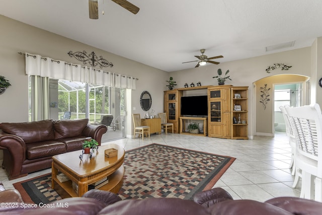 386 Valencia Rd, Melbourne, FL 32904 - living room with ceiling fan, light tile patterned floors, and arched walkways