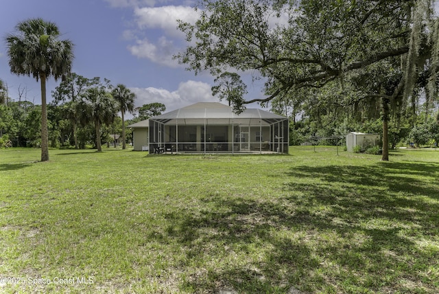 386 Valencia Rd, Melbourne, FL 32904 - view of grassy yard featuring a storage unit and glass enclosure