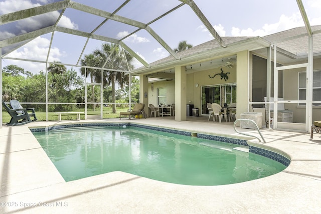 386 Valencia Rd, Melbourne, FL 32904 - outdoor pool featuring a patio, a ceiling fan, and glass enclosure