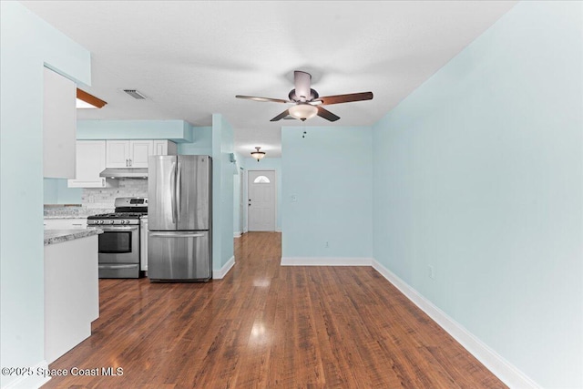 1527 Spruce Rd, Melbourne, FL 32935 - kitchen with appliances with stainless steel finishes, under cabinet range hood, ceiling fan, white cabinetry, and dark wood finished floors