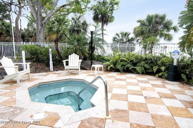 225 S Tropical Trl Unit 607, Merritt Island, FL 32952 - view of swimming pool with a community hot tub, a fenced backyard, a patio, and a pool