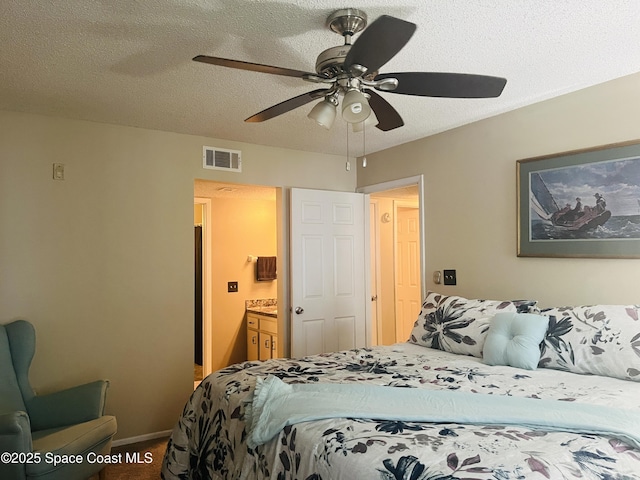 225 S Tropical Trl Unit 607, Merritt Island, FL 32952 - carpeted bedroom featuring a textured ceiling, ceiling fan, and ensuite bath