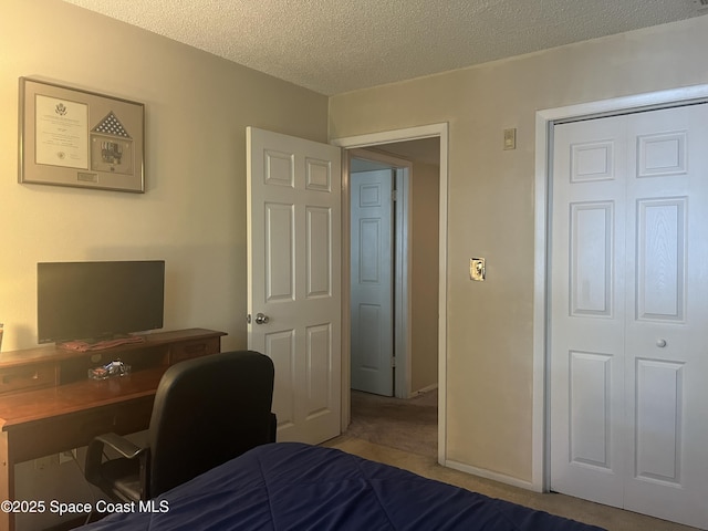 225 S Tropical Trl Unit 607, Merritt Island, FL 32952 - bedroom with a textured ceiling, an office area, and carpet
