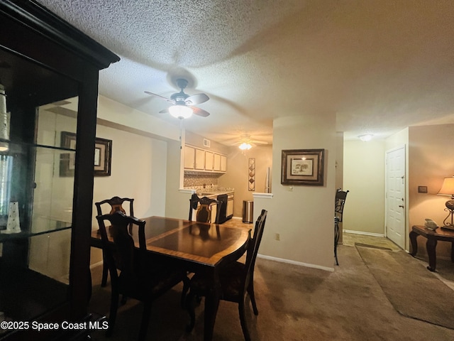 225 S Tropical Trl Unit 607, Merritt Island, FL 32952 - dining room with a textured ceiling, a ceiling fan, dark colored carpet, and baseboards