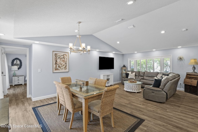 1021 Sunswept Rd NE, Palm Bay, FL 32905 - dining space with a chandelier, wood finished floors, vaulted ceiling, and recessed lighting
