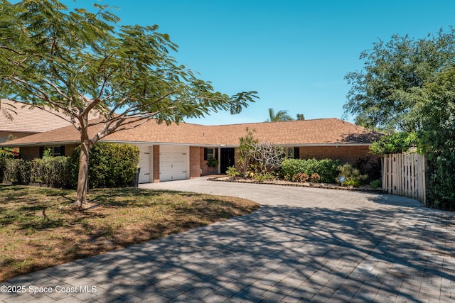 1021 Sunswept Rd NE, Palm Bay, FL 32905 - single story home with driveway, brick siding, and a garage