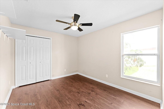 1211 Olde Bailey Ln, Melbourne, FL 32904 - unfurnished bedroom featuring wood finished floors, a closet, ceiling fan, and a textured ceiling