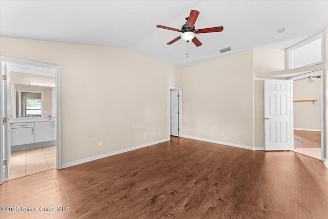 1211 Olde Bailey Ln, Melbourne, FL 32904 - unfurnished bedroom featuring wood finished floors, lofted ceiling, ensuite bathroom, and ceiling fan