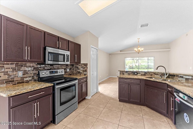 1211 Olde Bailey Ln, Melbourne, FL 32904 - kitchen with appliances with stainless steel finishes, lofted ceiling, backsplash, a chandelier, and light tile patterned flooring