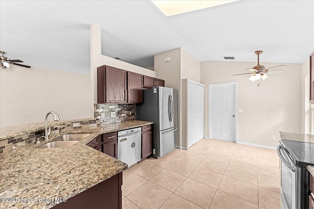 1211 Olde Bailey Ln, Melbourne, FL 32904 - kitchen with stainless steel appliances, a ceiling fan, tasteful backsplash, lofted ceiling, and light stone countertops
