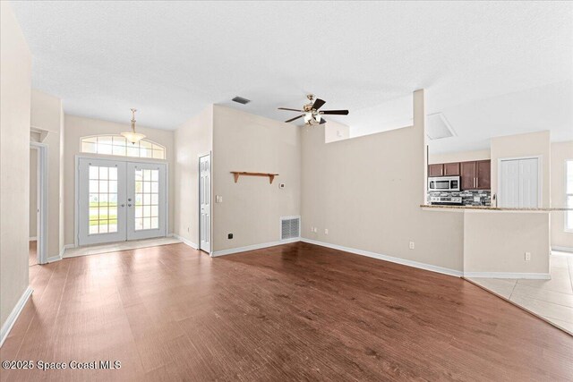 1211 Olde Bailey Ln, Melbourne, FL 32904 - unfurnished living room with french doors, wood finished floors, and a ceiling fan