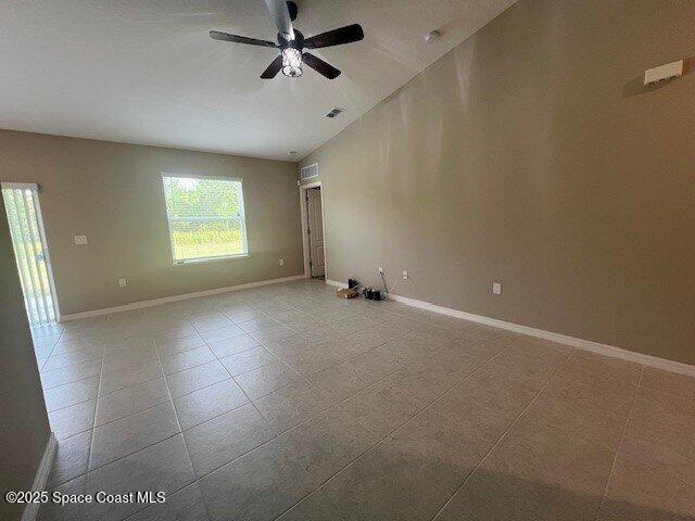 465 Hatcher St SE, Palm Bay, FL 32909 - spare room featuring a ceiling fan, baseboards, and tile patterned flooring