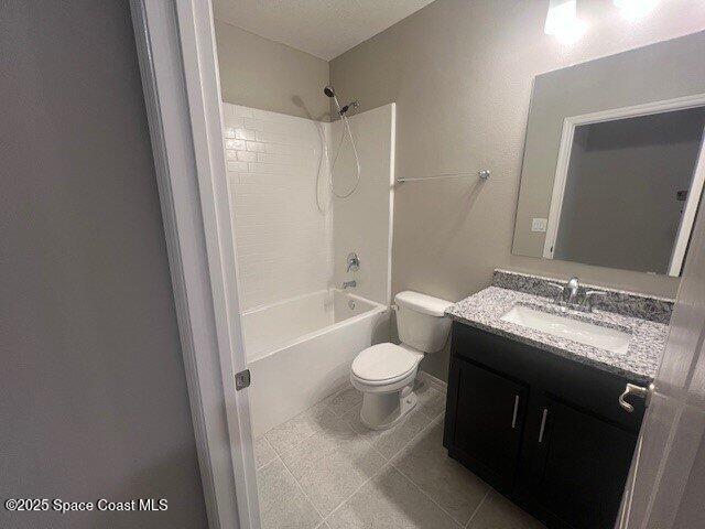 465 Hatcher St SE, Palm Bay, FL 32909 - bathroom with toilet, vanity, shower / washtub combination, and tile patterned floors