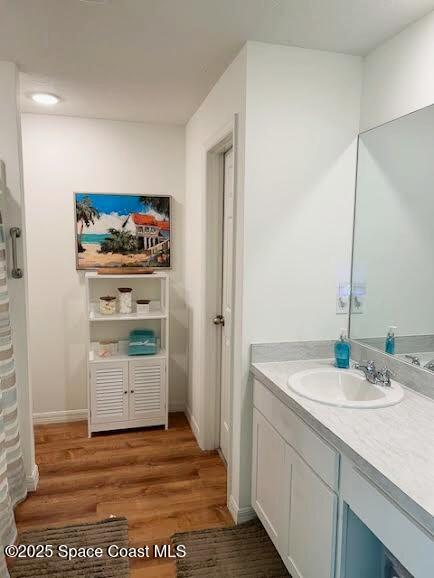 1119 Blossom Dr, Sebastian, FL 32958 - full bath featuring vanity, wood finished floors, curtained shower, and baseboards
