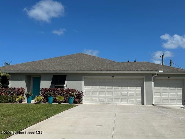 1119 Blossom Dr, Sebastian, FL 32958 - ranch-style home featuring concrete driveway, an attached garage, stucco siding, and a front lawn