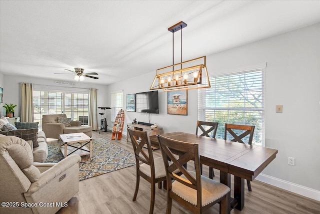 530 S Brevard Ave Unit 315, Cocoa Beach, FL 32931 - dining area featuring light wood-style floors, a ceiling fan, and a chandelier