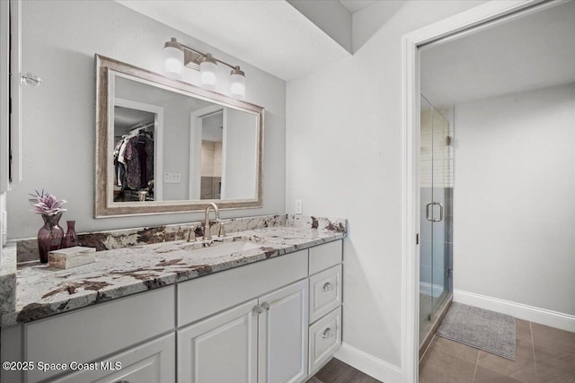530 S Brevard Ave Unit 315, Cocoa Beach, FL 32931 - bathroom featuring vanity, a shower stall, a spacious closet, and tile patterned flooring