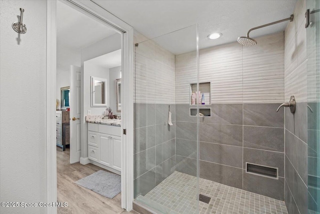 530 S Brevard Ave Unit 315, Cocoa Beach, FL 32931 - full bathroom with vanity, a stall shower, wood finished floors, and recessed lighting