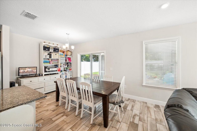 848 Brookview Ln, Rockledge, FL 32955 - dining room featuring light wood-style flooring and a chandelier