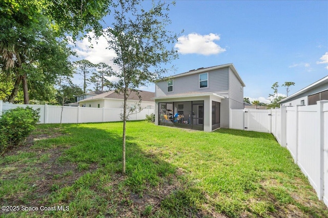 848 Brookview Ln, Rockledge, FL 32955 - rear view of property featuring a sunroom, a fenced backyard, and a gate