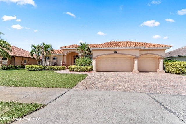 3631 Thurloe Dr, Rockledge, FL 32955 - mediterranean / spanish-style house featuring stucco siding, a garage, decorative driveway, a front yard, and a tiled roof