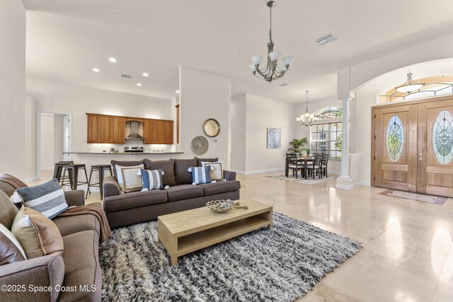 3631 Thurloe Dr, Rockledge, FL 32955 - living area featuring a chandelier, decorative columns, recessed lighting, arched walkways, and baseboards