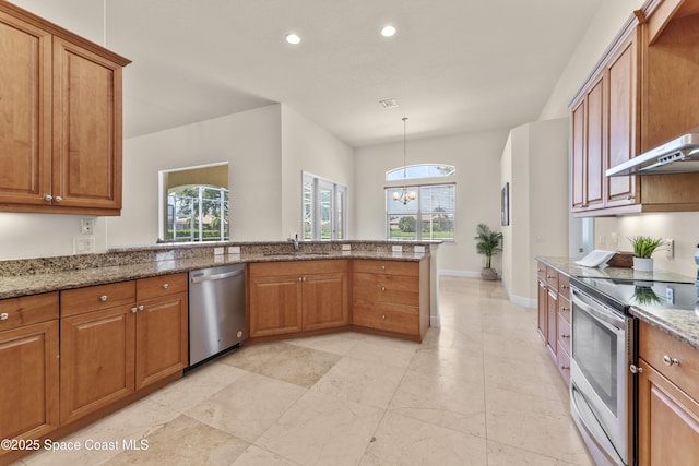 3631 Thurloe Dr, Rockledge, FL 32955 - kitchen with appliances with stainless steel finishes, brown cabinets, a peninsula, light stone counters, and recessed lighting