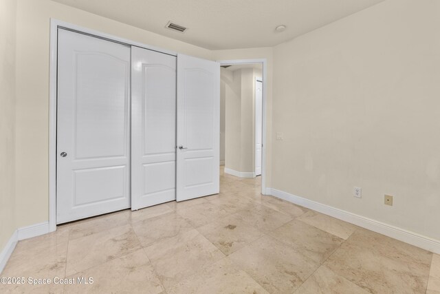 3631 Thurloe Dr, Rockledge, FL 32955 - unfurnished bedroom with baseboards and a closet