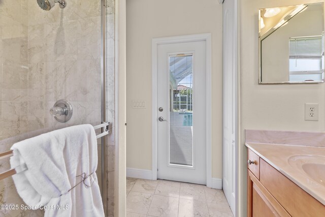 3631 Thurloe Dr, Rockledge, FL 32955 - full bathroom with a stall shower, vanity, baseboards, and marble look tiles