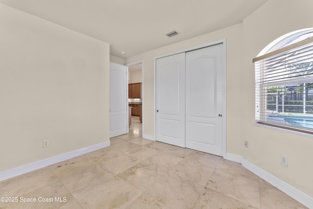 3631 Thurloe Dr, Rockledge, FL 32955 - unfurnished bedroom featuring a closet and baseboards