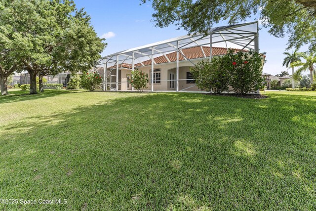 3631 Thurloe Dr, Rockledge, FL 32955 - rear view of property featuring a yard and glass enclosure