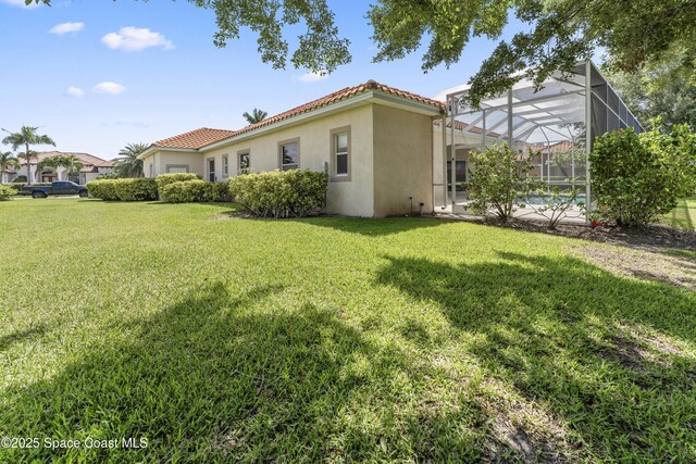 3631 Thurloe Dr, Rockledge, FL 32955 - view of green lawn featuring glass enclosure and an outdoor pool