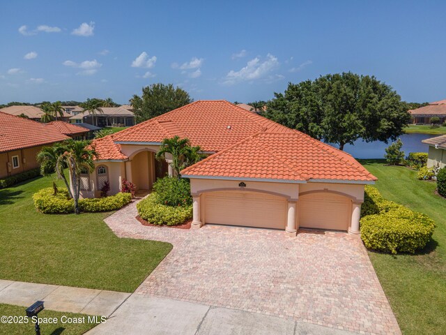 3631 Thurloe Dr, Rockledge, FL 32955 - mediterranean / spanish-style home featuring an attached garage, a front lawn, driveway, and stucco siding
