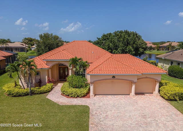3631 Thurloe Dr, Rockledge, FL 32955 - mediterranean / spanish home with an attached garage, a front yard, stucco siding, driveway, and a tile roof