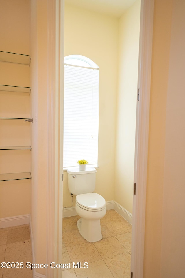 3631 Thurloe Dr, Rockledge, FL 32955 - bathroom with toilet, baseboards, and tile patterned floors
