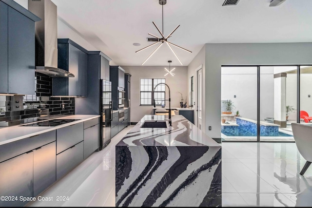 2365 Reeling Cir, Melbourne, FL 32940 - kitchen featuring wall chimney exhaust hood, backsplash, black electric cooktop, hanging light fixtures, and oven