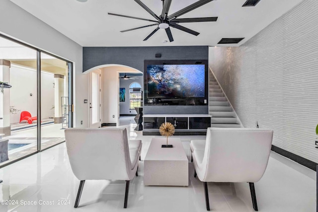 2365 Reeling Cir, Melbourne, FL 32940 - living area with ceiling fan, arched walkways, and stairs