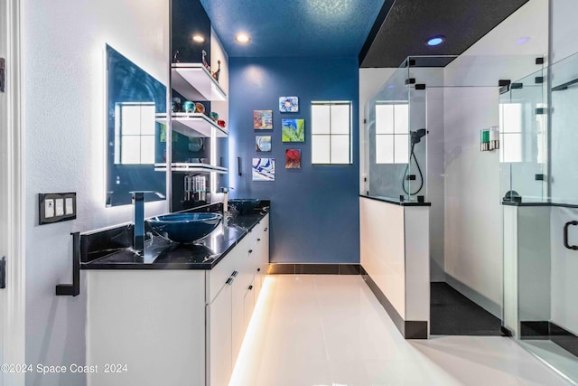 2365 Reeling Cir, Melbourne, FL 32940 - kitchen with a sink, baseboards, white cabinets, recessed lighting, and dark countertops