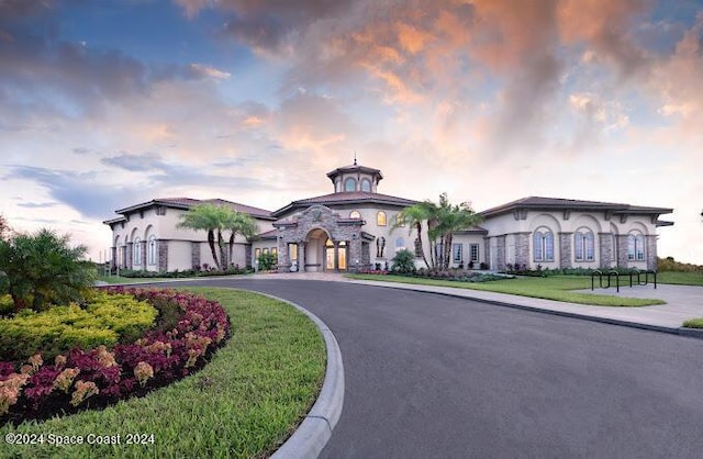 2365 Reeling Cir, Melbourne, FL 32940 - property at dusk featuring curved driveway