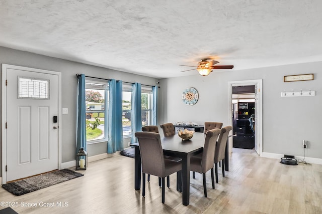 348 Berkeley St, Satellite Beach, FL 32937 - dining space featuring light wood-style flooring, a ceiling fan, and a textured ceiling