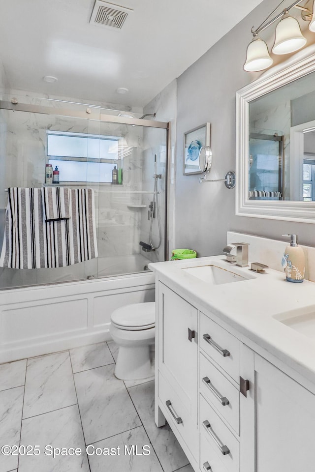 348 Berkeley St, Satellite Beach, FL 32937 - bathroom featuring marble look tile flooring, double vanity, and enclosed tub / shower combo