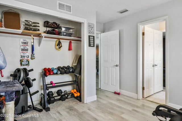 348 Berkeley St, Satellite Beach, FL 32937 - workout room with wood finished floors and baseboards