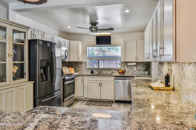 348 Berkeley St, Satellite Beach, FL 32937 - kitchen with appliances with stainless steel finishes, a ceiling fan, light stone counters, light wood-type flooring, and recessed lighting